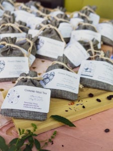 Dozens of burlap sacks with tea and coffee inside for Garlic Delight DIY wedding favor tutorial