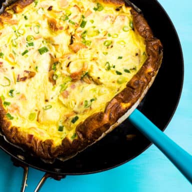 A spatula lifting a crustless quiche out of a pan