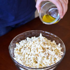 Garlic Butter Popcorn-Pour butter over the popcorn