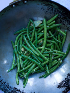 Overhead view of green beans in wok
