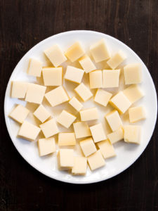 Cubes of cheese on a white plate