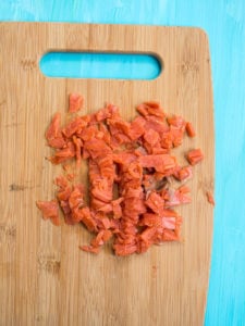 Chopped smoked salmon on bamboo cutting board