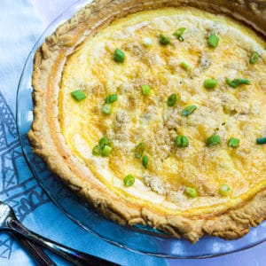 Close up look of a quiche lorraine with green onions
