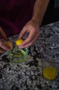 Overhead shot of separating egg whites from egg yolks. Recipe from garlicdelight.com.