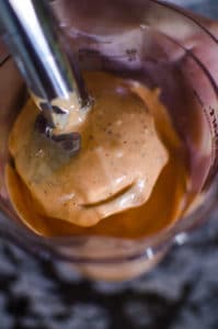 Close up shot of mayonnaise on the immersion blender. Recipe from garlicdelight.com.