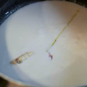 Add all of the lemongrass roots and leaves to the coconut cream